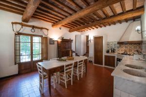 a kitchen with a large wooden table and chairs at Ca Nova Sud in Siena