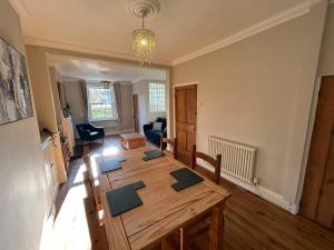 a living room with a wooden table in a room at 2 Bedroom Home Full Of Character in Nantwich