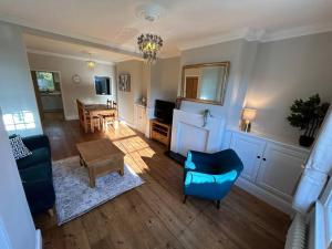 a living room with a couch and a table at 2 Bedroom Home Full Of Character in Nantwich
