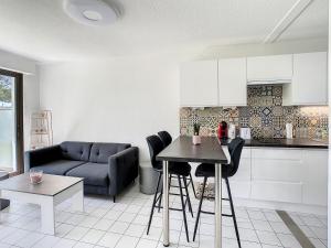 a living room with a couch and a table at Le Phare in Royan