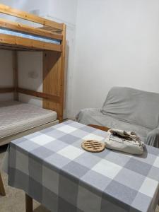 a table with a pair of shoes on top of a bed at Le nid in La Bourboule