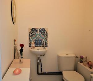 a bathroom with a toilet and a sink at Lovely flat close Paris Disney. in Neuilly-sur-Marne