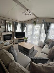 uma sala de estar com um sofá e uma mesa em Sun sea and sand at Whitley bay caravan park em Whitley Bay