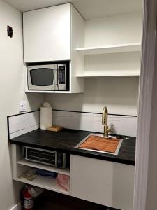 eine Küche mit einer Spüle und einer Mikrowelle in der Unterkunft Park City Southwestern Bunker in Park City