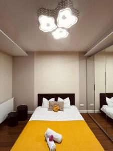 um quarto com uma cama grande e um cobertor amarelo em Apartament Mecenasa na Cracóvia