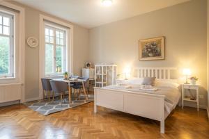 a bedroom with a bed and a table with chairs at Vila Na Landeku in Ostrava