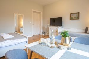 a living room with a table and blue chairs at Vila Na Landeku in Ostrava