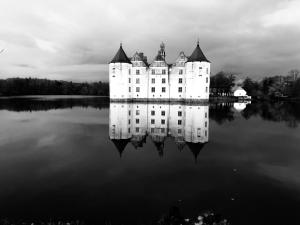 a castle sitting on top of a body of water at Sweet vacation in Harrislee
