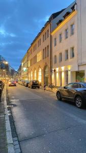 a street with cars parked on the side of a building at City NOWA in Nürnberg