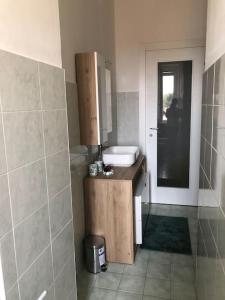 a bathroom with a sink and a mirror at A Casa di Katia in Collegno