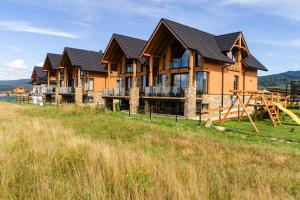 a large house with a playground on a hill at Rezydencja Widok in Kluszkowce