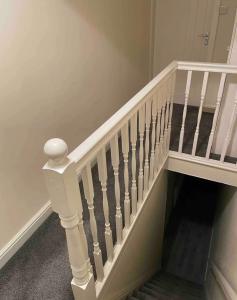 a staircase with white railings in a home at Ensuite Room, Hotel Standard. Close to Crewe Train Station in Crewe