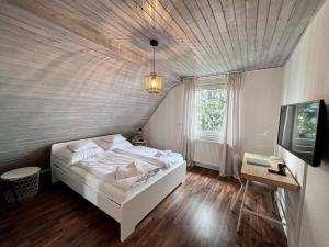 1 dormitorio con cama, mesa y TV en Top Wohnung mit Parkplatz, en Paderborn