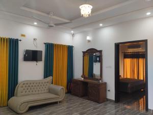 sala de estar con sofá y espejo en ITL GUESTHOUSE en Rawalpindi