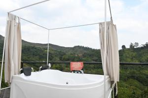 a white bath tub in front of a window at GLAMPING LA CRISTALINA in Jamundí