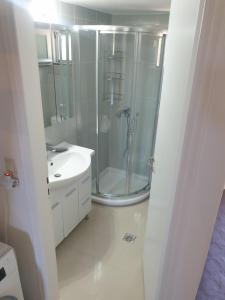 a bathroom with a shower and a sink at Aeolus pool apts in Palekastron +32 photos