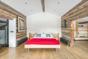 a bedroom with a bed with a red blanket at Spectacular Chalet with 5 ensuite bedrooms and sauna in Chamonix-Mont-Blanc