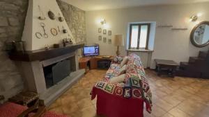 a living room with a couch and a fireplace at Vale House in Faidello