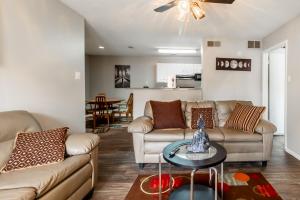 a living room with two couches and a table at Heart of Huntsville in Huntsville