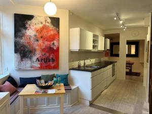 a kitchen with a table and a counter top at Central, Historical, Unique & Modern Apartment CPH in Copenhagen +5 photos