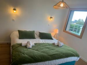 two stuffed animals on a bed in a bedroom at Ty Maneguy - Maison neuve et confortable in Vannes