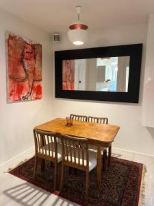 a dining room table with two chairs and a mirror at Central, Historical, Unique & Modern Apartment CPH in Copenhagen