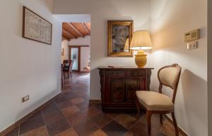 um corredor com uma mesa, uma cadeira e um candeeiro em A Casa del Gioielliere em Palermo