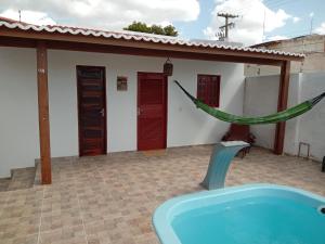 a pool in front of a house with a house at Minha casa in Mossoró