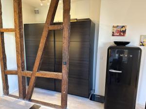 a wooden ladder next to a refrigerator in a room at Central, Historical, Unique & Modern Apartment CPH in Copenhagen