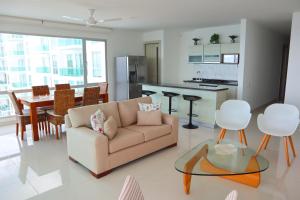 sala de estar con sofá, mesa y cocina en Magico Apartamento Frente al Mar 4 Habitaciones O62, en Coveñas