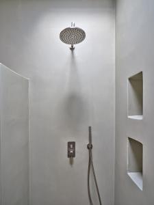 a bathroom with a shower with a shower head at Private Luxury Scarlet beachfront villa, Molos, Paros in Molos Parou
