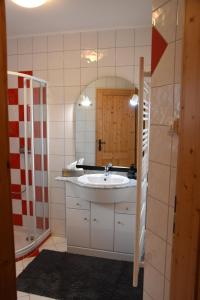 a bathroom with a sink and a mirror at Wein & Wohnen MATZL - Ferienwohnung in Fürstenfeld