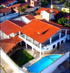 an overhead view of a house with an orange roof at Pousada e Hostel Lua de Tomate in Caucaia