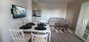 a living room with a table with hats on it at Studio Grand Confort à Houilles in Houilles