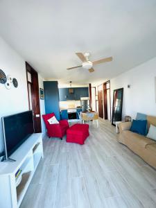 a living room with a couch and a flat screen tv at Apartamento Bungamerica 2 bedrooms Costa Adeje in Playa de las Americas