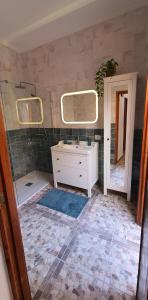 a bathroom with a sink and a mirror at Puerto Mogan Casa Feliz in Puerto de Mogán