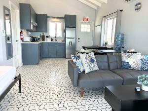 a living room with a couch and a kitchen at Villas Secreta Beachfront Resort in San Pedro