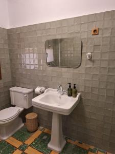 a bathroom with a sink and a toilet and a mirror at Casa rural El Moral by Fuentelgato in Huerta del Marquesado +18 photos