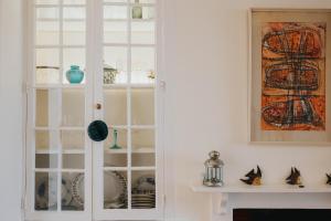 a white cabinet with glass doors in a living room at 3 bedroom stunning house with garden and amazing sea views in Dartmouth +25 photos