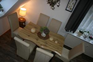 a dining room table and chairs with a wooden table at Ferien Oase am BER in Schönefeld