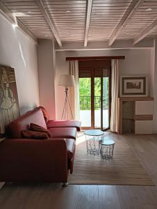 a living room with a couch and a table at La Casa de la Plaza in Güéjar-Sierra