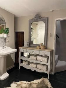 a bathroom with a sink and a mirror at 3-storey luxury Georgian house, High St, Henley-in-Arden in Henley in Arden