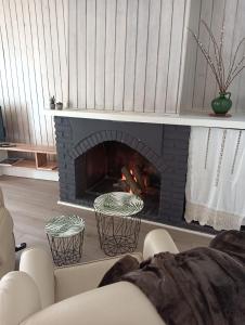 a fireplace in a living room with a fire place at La Casa de la Plaza in Güéjar-Sierra
