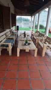 a group of wooden benches sitting on a patio at Agalma Aloha Boutique EvenT in Andino