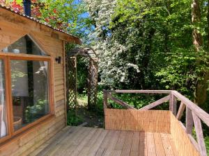 a wooden ramp leading to a house with a door at Honey Bee Cabin in Llandysul