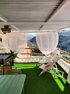 a balcony with a chair and a view of a mountain at la casita del pueblo PET friendly granada in Acebuches