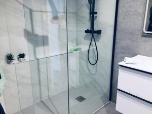 a shower with a glass door in a bathroom at Appartement centrum Calpé in Calpe +14 photos