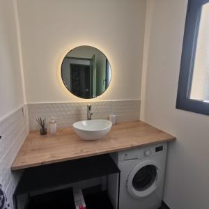 a bathroom with a sink and a washing machine at Villa Montélimar in Montélimar +16 photos