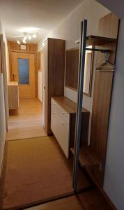 an empty room with a kitchen and a hallway at Apartment Marina in Wenns