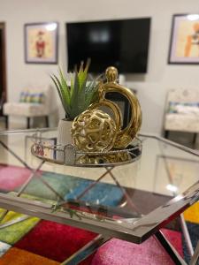 a glass table with a gold pineapple on top of it at Victory Luxury Apartments in Montego Bay